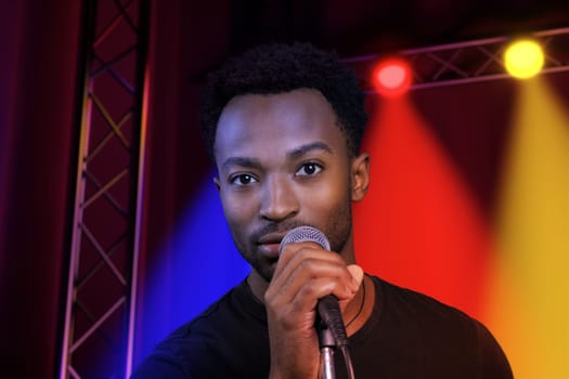 karaoke singer on stage music performance live show pop rock man holding microphone to sing