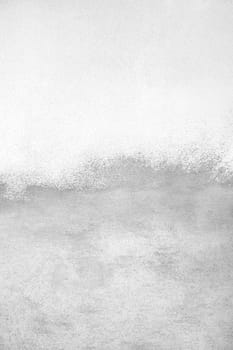 Concrete wall painted with white paint.