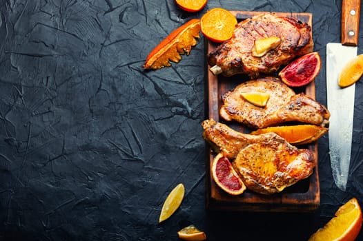 Juicy meat steak grilled in oranges. Meat in citrus marinade. Top view