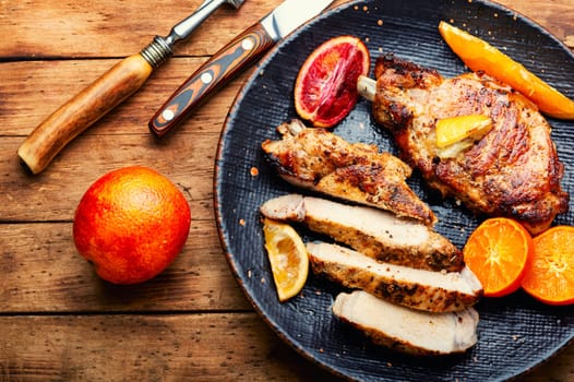 Juicy meat steak grilled in oranges. Meat in citrus marinade. Top view