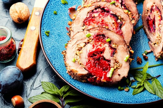 Sliced meatloaf stuffed with plums. Autumn meat recipe, roulade.