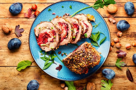 Sliced meatloaf stuffed with plums. Autumn meat recipe, roulade.