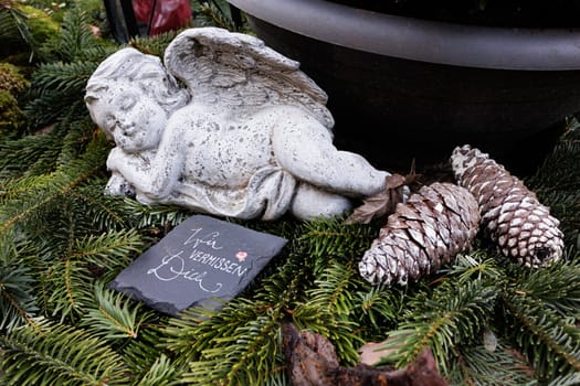 Angel on grave with lettering We miss you