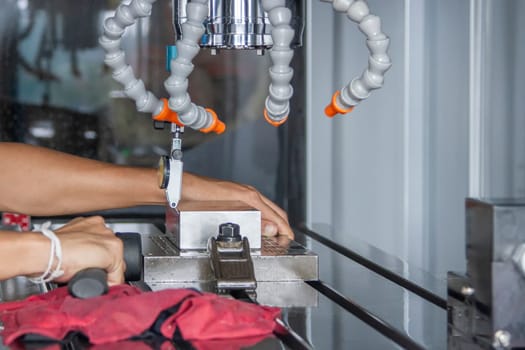 Man set up dial gauge for setting balance work   after cutting of CNC