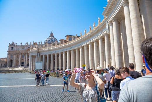 ROME, VATICAN STATE - AUGUST 24, 2018: long line of people waiting in front of Saint Peter Basilica entrance. Concept for overtourism and mass-tourism.