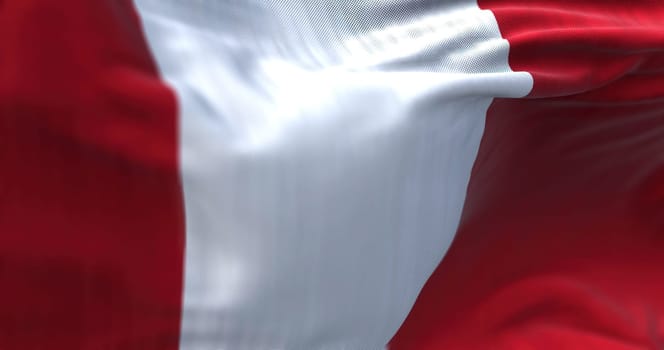 Close-up view of the Peru national flag waving in the wind. The Republic of Peru is a country in western South America. Fabric textured background. Selective focus
