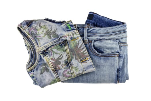 Women jeans fashion. A folded sleeveless blue jeans vest or jacket for woman and denim pants isolated on a white background. Clipping path.