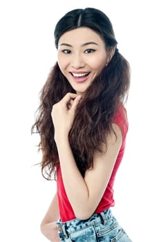 Sideways of beautiful girl looking at camera