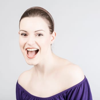Young pretty woman laughs warmly
