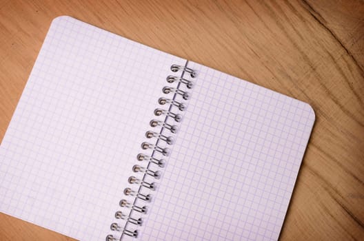 Blank notebook on a rustic wooden background