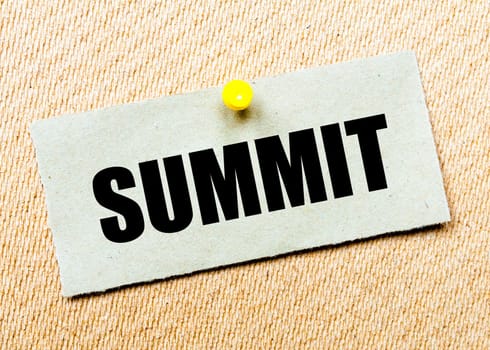 Recycled paper note pinned on cork board with word SUMMIT. Concept Image