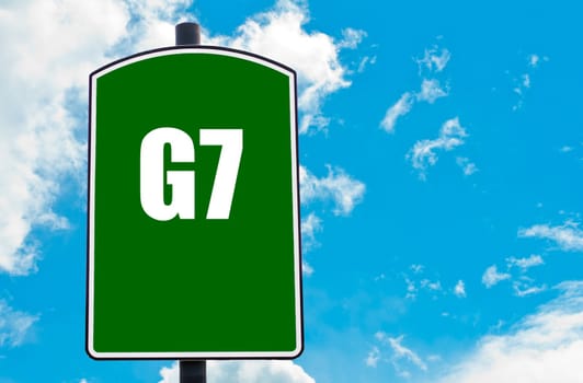 G7 SUMMIT written on green road sign  against clear blue sky background. Concept image with available copy space