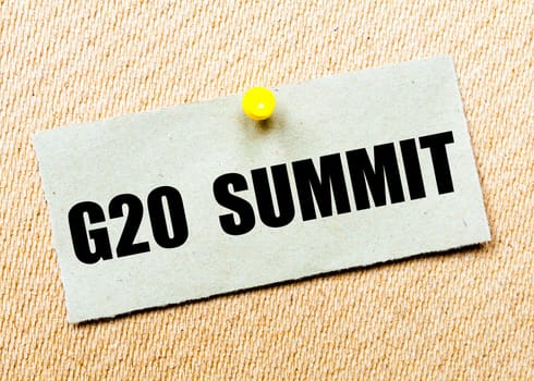 Recycled paper note pinned on cork board with words G20 SUMMIT. Concept Image