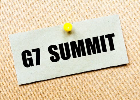 Recycled paper note pinned on cork board with words G7 SUMMIT. Concept Image