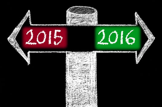 Opposite arrows with Year 2015 versus Year 2016. Hand drawing with chalk on blackboard. Choice conceptual image
