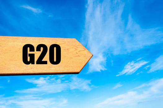 Wooden arrow sign pointing destination  G20 SUMMIT against clear blue sky with copy space available. Travel destination concept  image