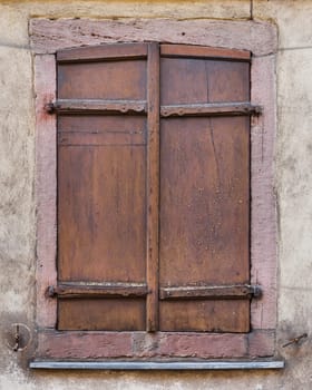 old wooden shutter on a historical building in the old town of Colmar in France