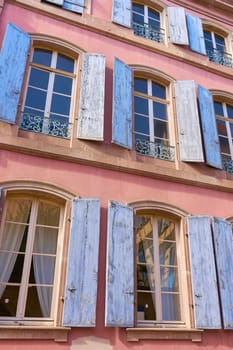 Windows with shutters on the facade of a house in the historic center of Colmar in France