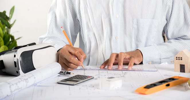 Architect workplace. Architectural building design and construction plans with blueprints paper project plans VR glasses, designing man edit a building or architecture with ruler, technology industry