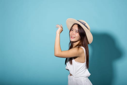 Portrait female raising arm and hand in protection and block sunshine, young woman hand up cover face protect sun light and UV in studio isolated on blue background, cosmetic sunscreen cream advertise