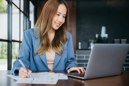 Business woman working with laptop computer she analyst financial advisor preparing statistic report studying documents, Businesswoman audit financial charts and graphs writing summary report data