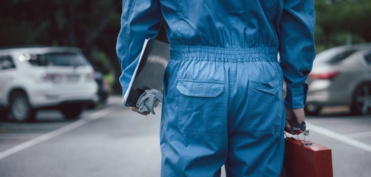Back mechanic man maintenance with tools togo service repair outdoor, Closeup of professional technician come to checking condition of car, The auto mechanic works car broken outside