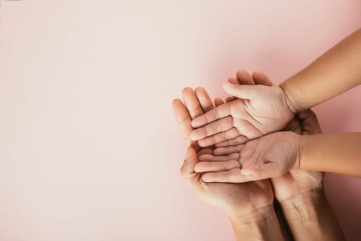Close up hands children on adult mother hand, Top view person kid stack mom palms, Parents and little kid holding empty hands together isolated on pink background, Family day care concept