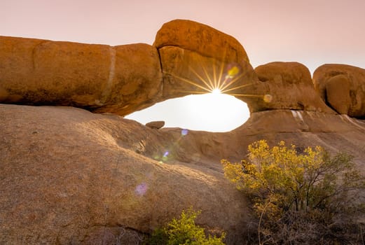 Rock arch at sunset in the Spitzkoppe National Park in Namibia in Africa.