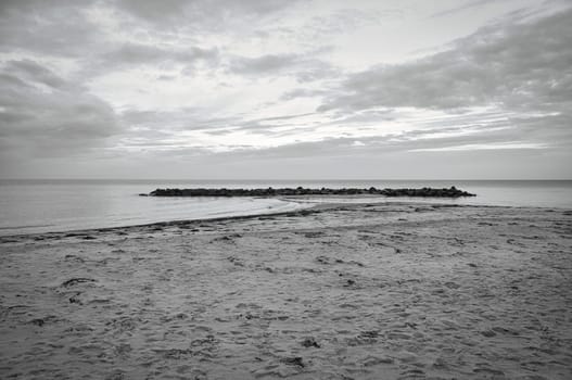 Hundested, Denmark on the cliff overlooking the sea. Baltic Sea coast, grassy meadow, beach. Clouds on horizon. Landscape photo from Scandinavia.