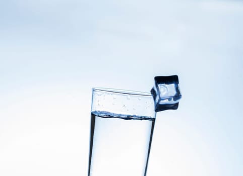 The image of pouring drinking water, into a glass, that makes one feel refreshed on blurred white background, Splashing water, Sparkling water