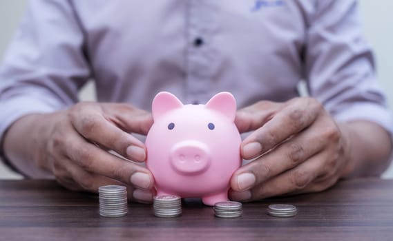 Money and financial concept, Save money and account banking for finance concept, Piggy bank with coin on blurred background