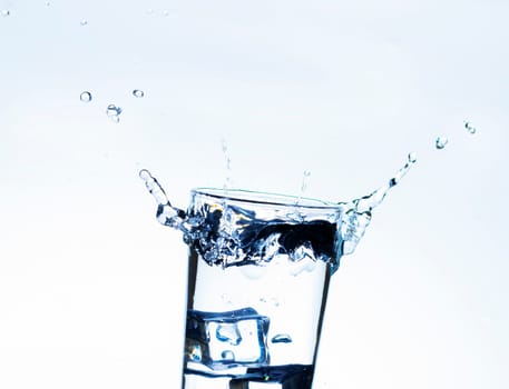 The image of pouring drinking water, into a glass, that makes one feel refreshed on blurred white background, Splashing water, Sparkling water