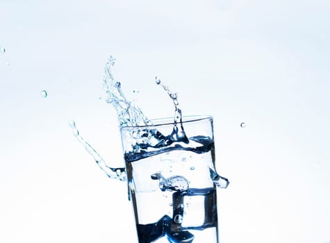 The image of pouring drinking water, into a glass, that makes one feel refreshed on blurred white background, Splashing water, Sparkling water