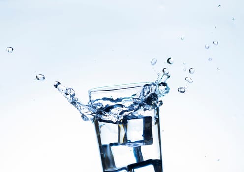 The image of pouring drinking water, into a glass, that makes one feel refreshed on blurred white background, Splashing water, Sparkling water