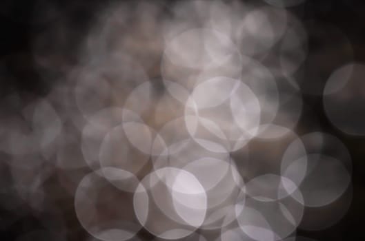 Light abstract dark bokeh christmas circle color glitter blurred black background