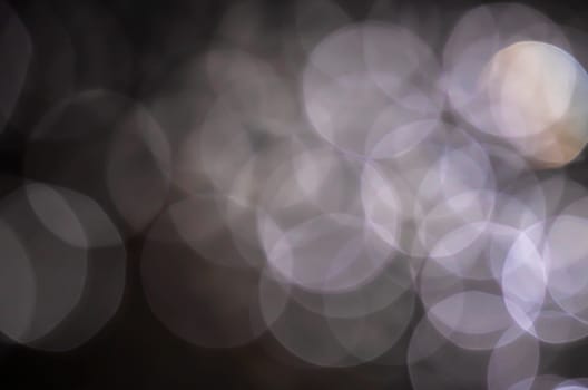 Light abstract dark bokeh christmas circle color glitter blurred black background