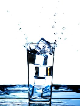The image of pouring drinking water, into a glass, that makes one feel refreshed on blurred white background, Splashing water, Sparkling water