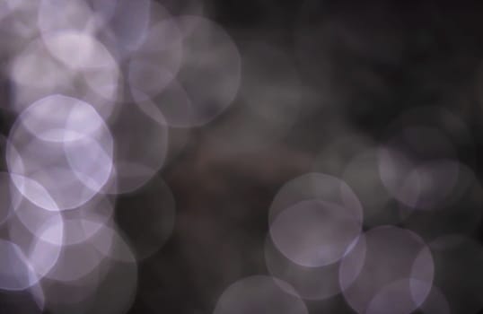 Light abstract dark bokeh christmas circle color glitter blurred black background