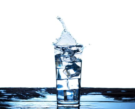 The image of pouring drinking water, into a glass, that makes one feel refreshed on blurred white background, Splashing water, Sparkling water