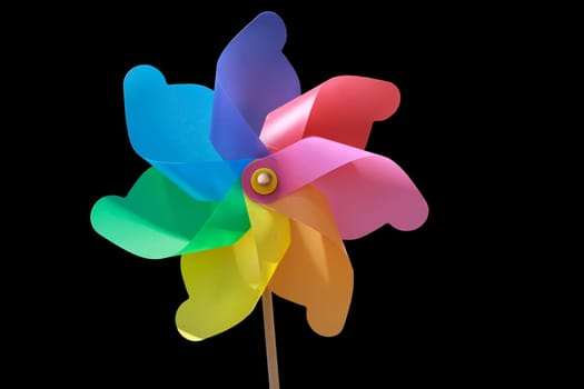 A plastic windmill with a wooden handle. Not a toy for children.