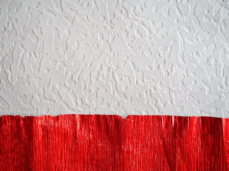 Corrugated paper in red. Uneven surface. Abstract background. Wavy edges of the paper sheet. Lighting gradient.
