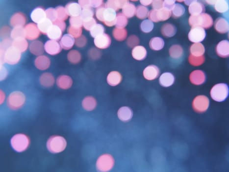 Beautiful side on a dark background. Pink shimmer and circles on a blue and gray background. Festive abstract background.