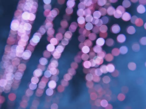 Beautiful side on a dark background. Pink shimmer and circles on a blue and gray background. Festive abstract background.