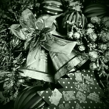 Christmas background with Christmas decorations, holiday balls, bells, bows, dots, fir cone, Christmas tinsel. Happy New Year and Merry Christmas. Black and white monochrome photo with green filter