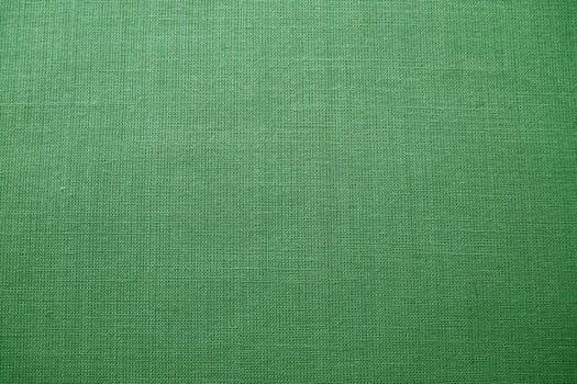 green background fabric texture. A piece of woolen cloth is neatly laid out on the surface. Weave and textile texture. Dress fabric or for kitchen needs, tablecloth or curtains, close-up. Dash.