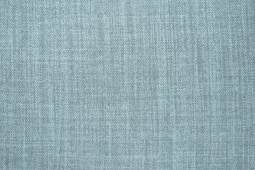 blue gray background fabric texture. A piece of woolen cloth is neatly laid out on the surface. Weave and textile texture. Dress fabric or for kitchen needs, tablecloth or curtains, close-up. Dash.