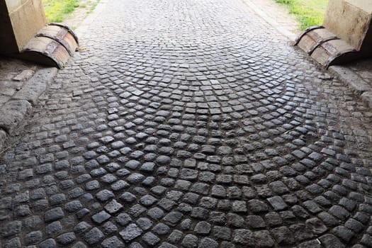 Paving stones - a hard road surface, a kind of pavement, lined with flat rectangular bars of the same shape and size. Block stone from which the road surface was built. Petrovaradin, Novi Sad, Serbia.