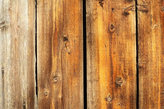 Close up wood with natural texture. The blank wooden template board can be used as a backdrop for top view product display or montage. High quality photo. Vertical brown boards with knots without gap.