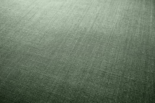 green background fabric texture. A piece of woolen cloth is neatly laid out on the surface. Weave and textile texture. Dress fabric or for kitchen needs, tablecloth or curtains, close-up. Dash.