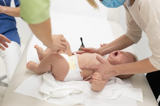 Baby beeing vaccinated by pediatrician in presence of his mother. Preventive vaccination against Diphtheria, whooping cough, tetanus, hepatitis, haemophilus influenzae, pneumococcus, poliomyelitis.